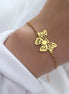 Bracelet Jakarta en acier inoxydable doré avec pendentif papillon ajouré. O-dace.com