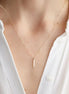 Collier Padang en acier inoxydable doré avec pendentif barre. O-dace.com